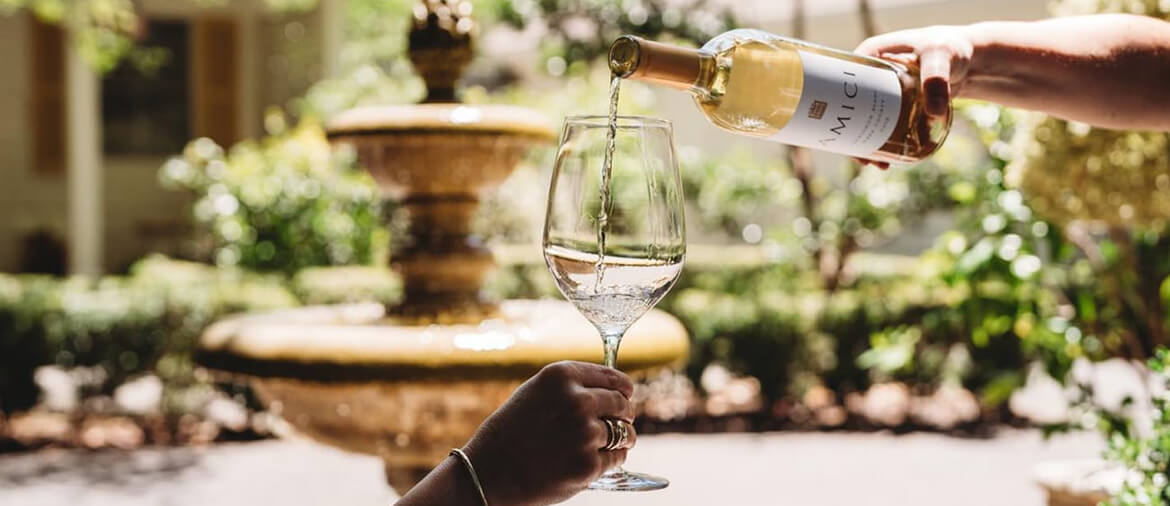 pouring a glass of white wine